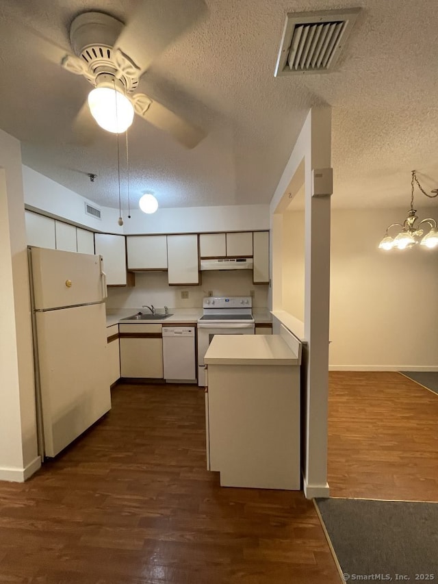 75 Washington Ave Unit 4207, Hamden, CT 06518 - kitchen with white appliances, under cabinet range hood, a sink, a textured ceiling, and light countertops