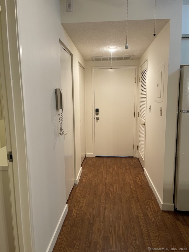 75 Washington Ave Unit 4207, Hamden, CT 06518 - hall featuring dark wood-style flooring, baseboards, a textured ceiling, and electric panel