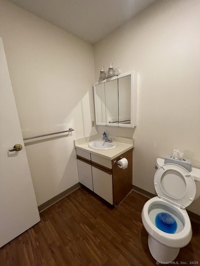75 Washington Ave Unit 4207, Hamden, CT 06518 - half bathroom with wood finished floors, toilet, vanity, and baseboards