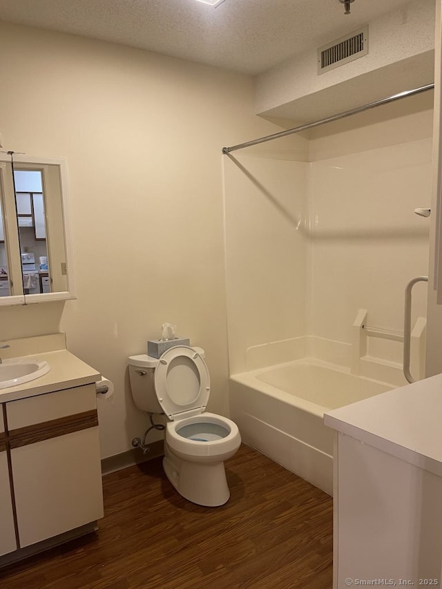 75 Washington Ave Unit 4207, Hamden, CT 06518 - full bath featuring vanity, toilet, wood finished floors, shower / bathtub combination, and a textured ceiling