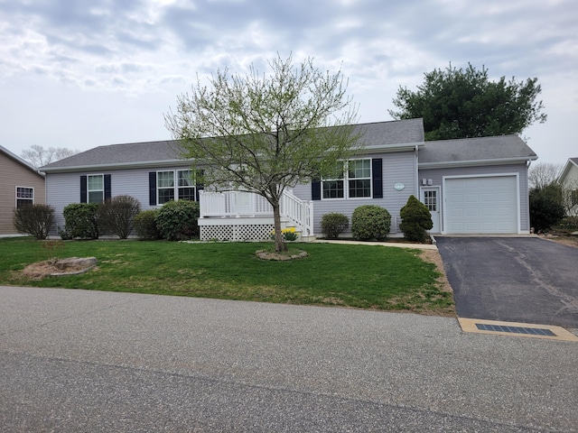 ranch-style home with driveway, a front yard, and a garage