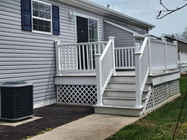 deck featuring cooling unit and stairs