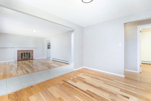 31 Mountain View Dr, Rocky Hill, CT 06067 - unfurnished living room featuring a baseboard heating unit, wood finished floors, and a brick fireplace
