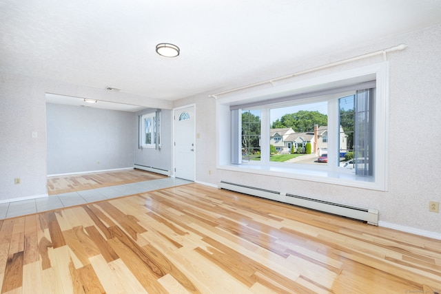 31 Mountain View Dr, Rocky Hill, CT 06067 - unfurnished living room with a baseboard heating unit, wood finished floors, and plenty of natural light