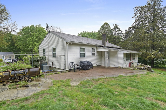 5 Stone Ct, Ledyard, CT 06335 - back of house with a patio area, a chimney, a lawn, and central air condition unit