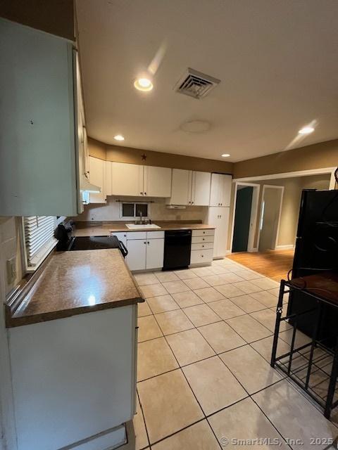 5 Stone Ct, Ledyard, CT 06335 - kitchen featuring black dishwasher, range, white cabinetry, light tile patterned floors, and under cabinet range hood