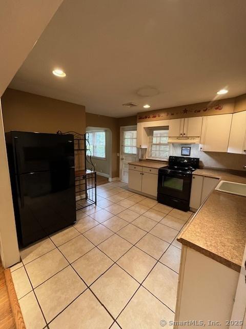 5 Stone Ct, Ledyard, CT 06335 - kitchen featuring black appliances, a sink, light tile patterned floors, white cabinets, and recessed lighting