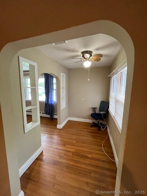5 Stone Ct, Ledyard, CT 06335 - unfurnished room with arched walkways, wood finished floors, plenty of natural light, and baseboards