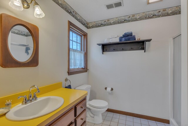 bathroom featuring tile patterned floors, vanity, baseboards, toilet, and visible vents