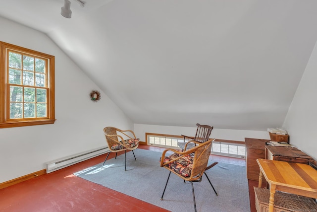 sitting room featuring a baseboard heating unit and lofted ceiling