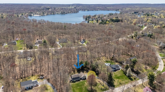 aerial view with a forest view and a water view