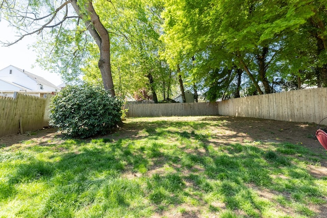 view of yard with a fenced backyard