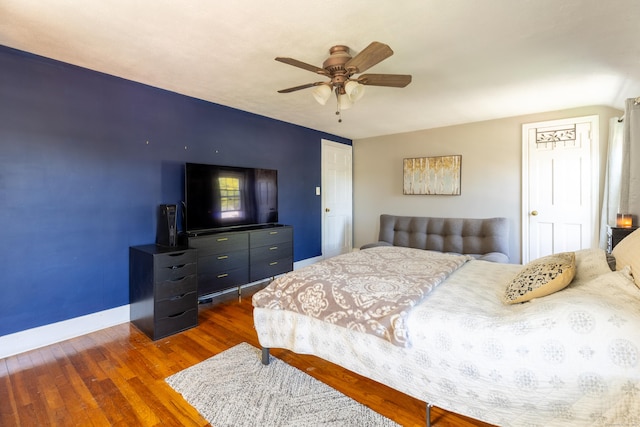 bedroom featuring baseboards, a ceiling fan, and wood finished floors