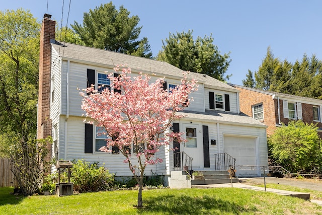 traditional-style house featuring a garage, a chimney, and a front yard