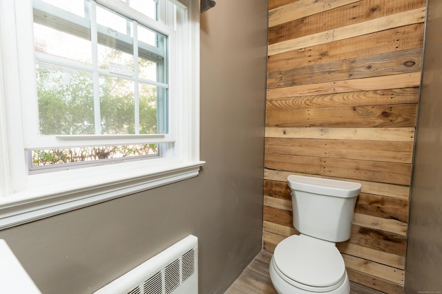 bathroom with wooden walls and toilet