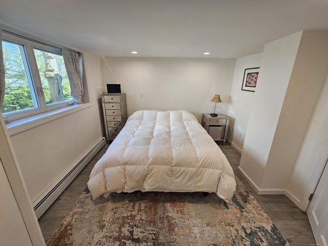 bedroom with recessed lighting, wood finished floors, baseboards, and baseboard heating