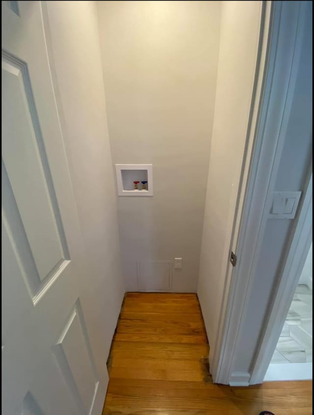 washroom featuring light wood-style flooring, laundry area, and hookup for a washing machine