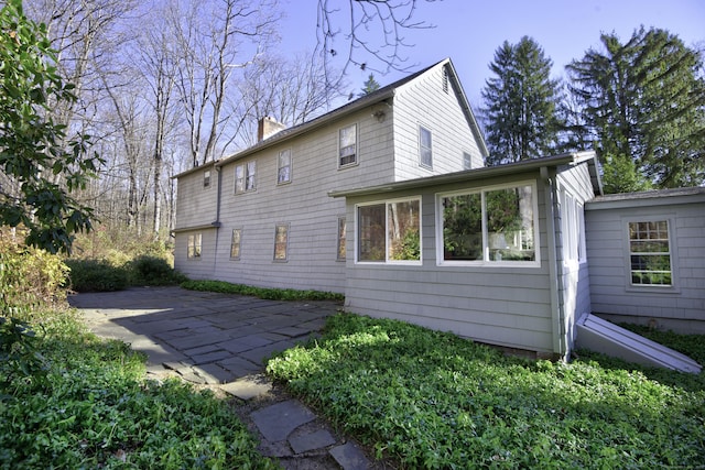 538 County Rd, Guilford, CT 06437 - back of property with a patio and a chimney