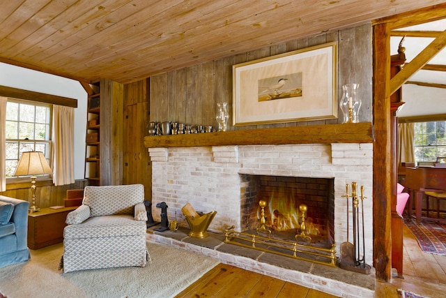 538 County Rd, Guilford, CT 06437 - sitting room featuring a brick fireplace, wood walls, wood ceiling, and hardwood / wood-style flooring