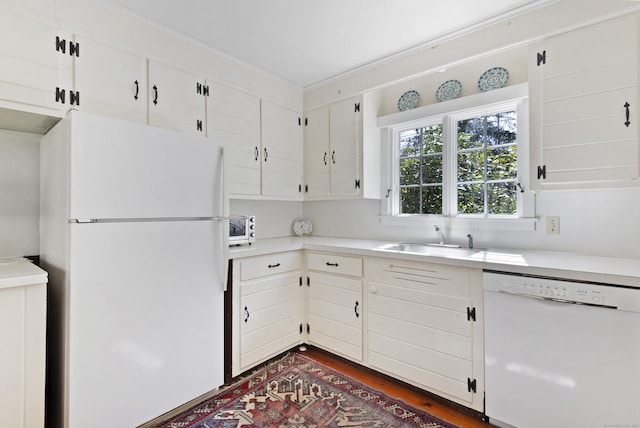 538 County Rd, Guilford, CT 06437 - kitchen with dark wood-style flooring, a sink, white appliances, light countertops, and white cabinetry