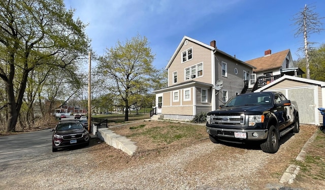 84 River Ave, Norwich, CT 06360 - view of side of home featuring a chimney, an outdoor structure, and a storage shed