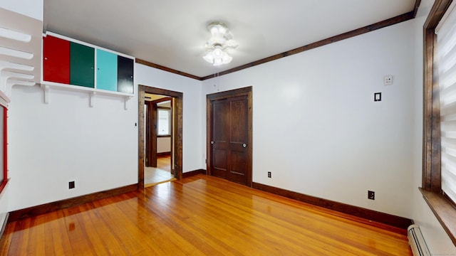 8 Kent St, Plainville, CT 06062 - spare room featuring a baseboard heating unit, light wood-type flooring, and baseboards