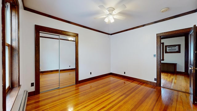 8 Kent St, Plainville, CT 06062 - unfurnished bedroom with wood-type flooring, baseboard heating, baseboards, crown molding, and a closet