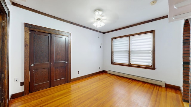 8 Kent St, Plainville, CT 06062 - unfurnished bedroom with baseboard heating, baseboards, light wood-type flooring, and a closet
