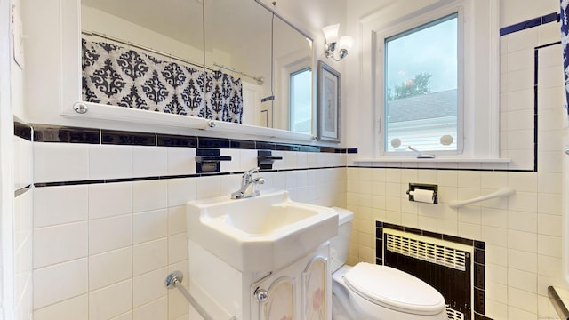 8 Kent St, Plainville, CT 06062 - full bathroom with radiator heating unit, toilet, tile walls, vanity, and a shower with curtain