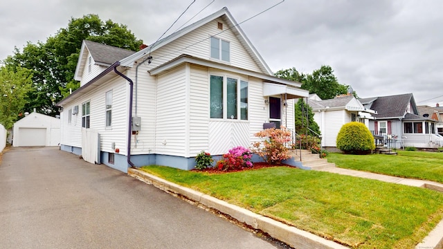 8 Kent St, Plainville, CT 06062 - view of front of property with a garage, an outdoor structure, driveway, and a front lawn
