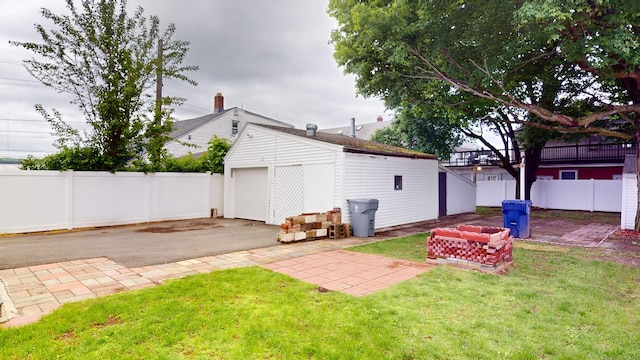 8 Kent St, Plainville, CT 06062 - view of yard with an outdoor structure, a garage, and asphalt driveway