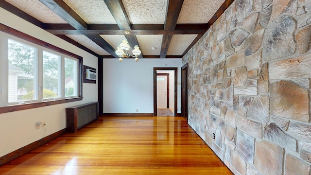 8 Kent St, Plainville, CT 06062 - empty room featuring light wood finished floors, radiator heating unit, beamed ceiling, a chandelier, and coffered ceiling