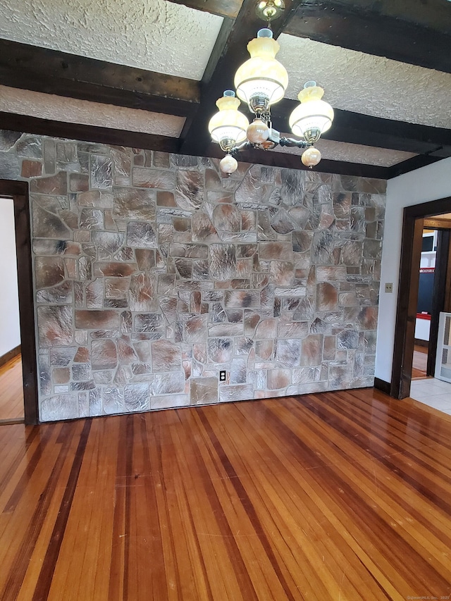 8 Kent St, Plainville, CT 06062 - unfurnished dining area featuring a chandelier, beamed ceiling, and wood finished floors