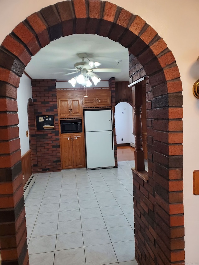 8 Kent St, Plainville, CT 06062 - kitchen featuring freestanding refrigerator, arched walkways, a baseboard radiator, a ceiling fan, and black microwave