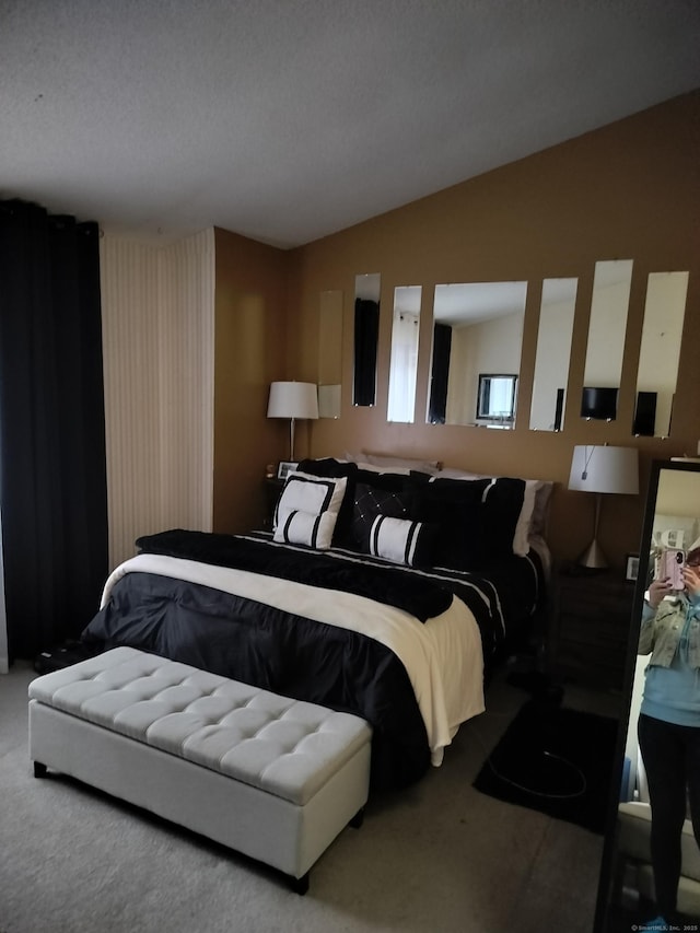 carpeted bedroom featuring lofted ceiling