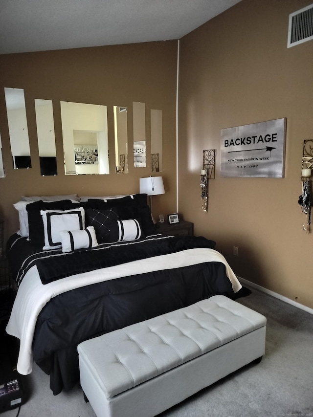 carpeted bedroom with vaulted ceiling, baseboards, and visible vents
