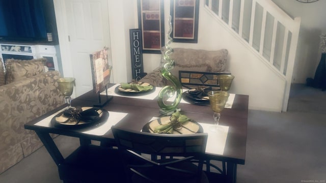 dining space featuring stairs