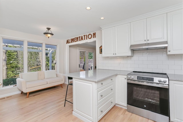 2 Donald Dr, Westport, CT 06880 - kitchen featuring stainless steel range with electric cooktop, under cabinet range hood, white cabinetry, a peninsula, and recessed lighting