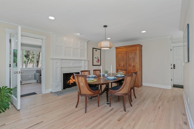 2 Donald Dr, Westport, CT 06880 - dining area with light wood-type flooring, a fireplace, baseboards, ornamental molding, and recessed lighting