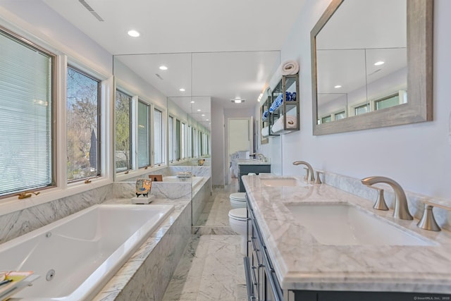 2 Donald Dr, Westport, CT 06880 - bathroom featuring toilet, marble tiled flooring, a jetted tub, double vanity, and recessed lighting