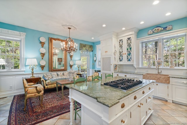 5 Northside Ln, Westport, CT 06880 - kitchen with stainless steel gas stovetop, white cabinetry, light stone countertops, a chandelier, and recessed lighting