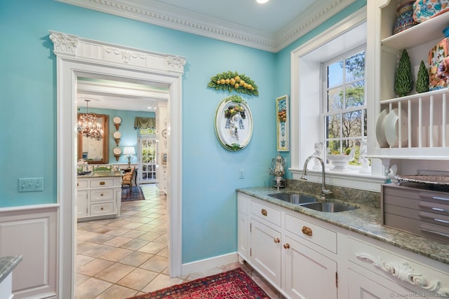 5 Northside Ln, Westport, CT 06880 - kitchen with white cabinets, light stone countertops, crown molding, and light tile patterned flooring
