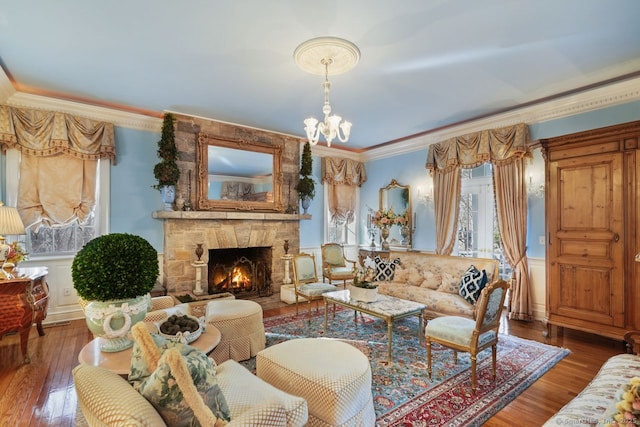 5 Northside Ln, Westport, CT 06880 - living room featuring crown molding, a stone fireplace, hardwood / wood-style flooring, and a chandelier
