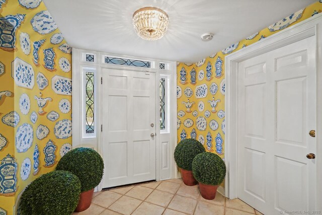 5 Northside Ln, Westport, CT 06880 - foyer featuring light tile patterned flooring, wallpapered walls, and a chandelier