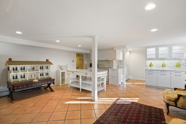 5 Northside Ln, Westport, CT 06880 - kitchen featuring backsplash, recessed lighting, white cabinets, light countertops, and light tile patterned floors