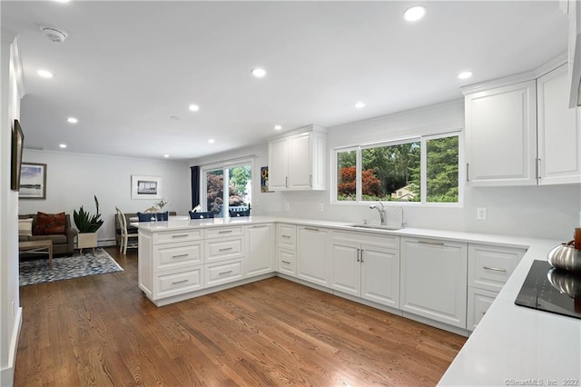 41 Hermit Ln, Westport, CT 06880 - kitchen with a peninsula, recessed lighting, white cabinetry, black electric cooktop, and a sink