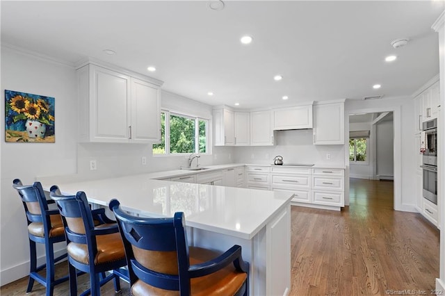 41 Hermit Ln, Westport, CT 06880 - kitchen with a sink, crown molding, a peninsula, and a wealth of natural light