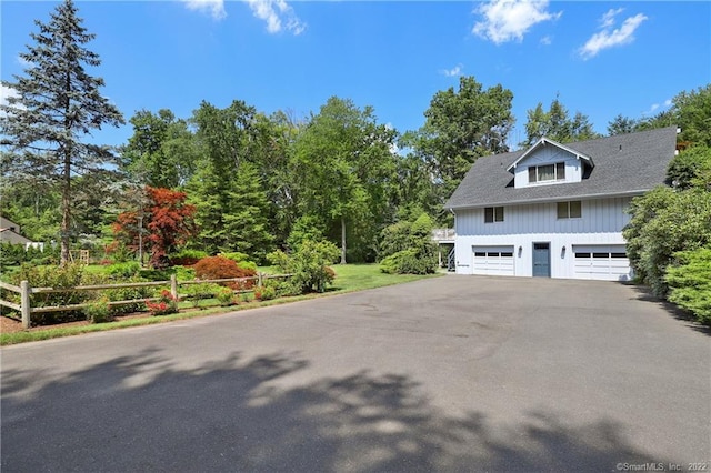 41 Hermit Ln, Westport, CT 06880 - view of side of home with board and batten siding, fence, and a detached garage