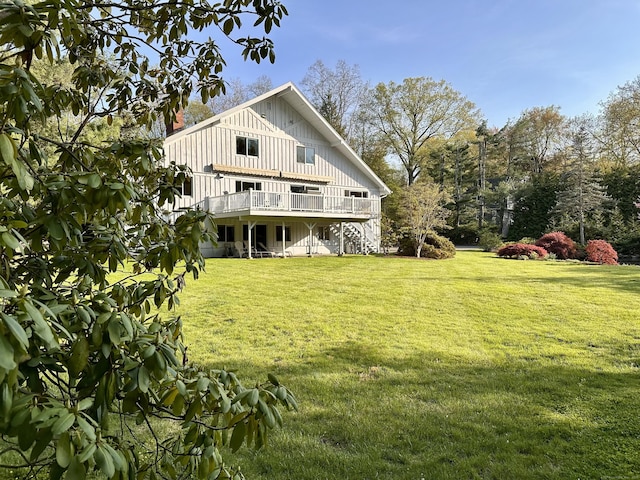 41 Hermit Ln, Westport, CT 06880 - back of house featuring a lawn, board and batten siding, and a deck