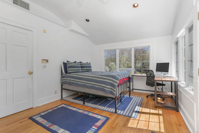 bedroom featuring vaulted ceiling, visible vents, and hardwood / wood-style floors